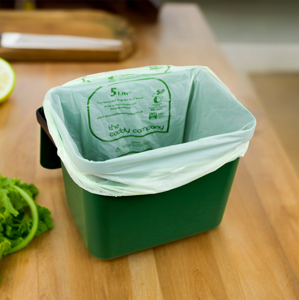 Caddy Company 5L kitchen liner in Easy Eco food waste caddy on wooden kitchen countertop