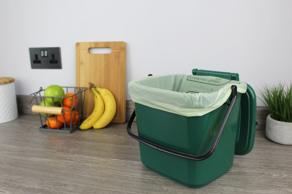 Medium green food waste caddy lined with a 7 litre compost liner, perfect for eco-friendly kitchen composting and odour control.
