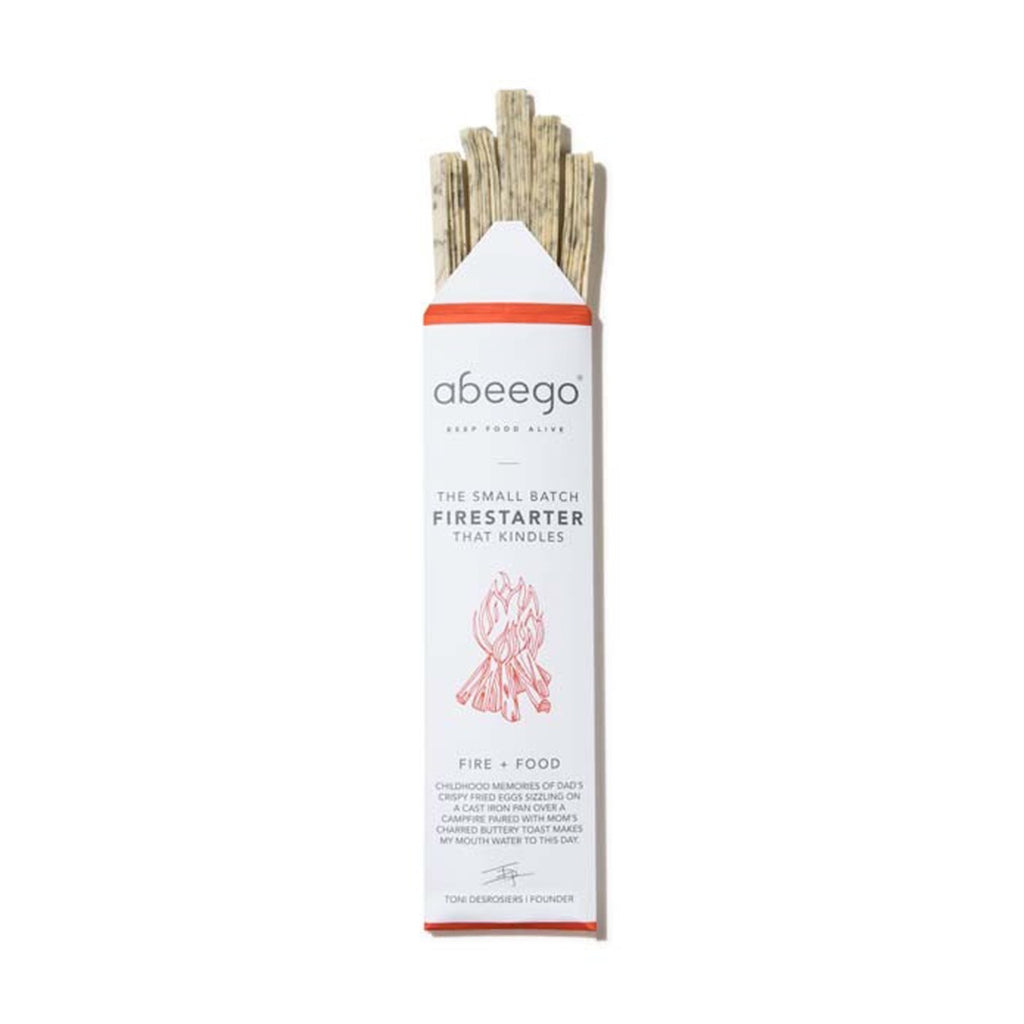 Abeego small batch firestarter in white packaging with red flame graphic and beeswax strips visible
