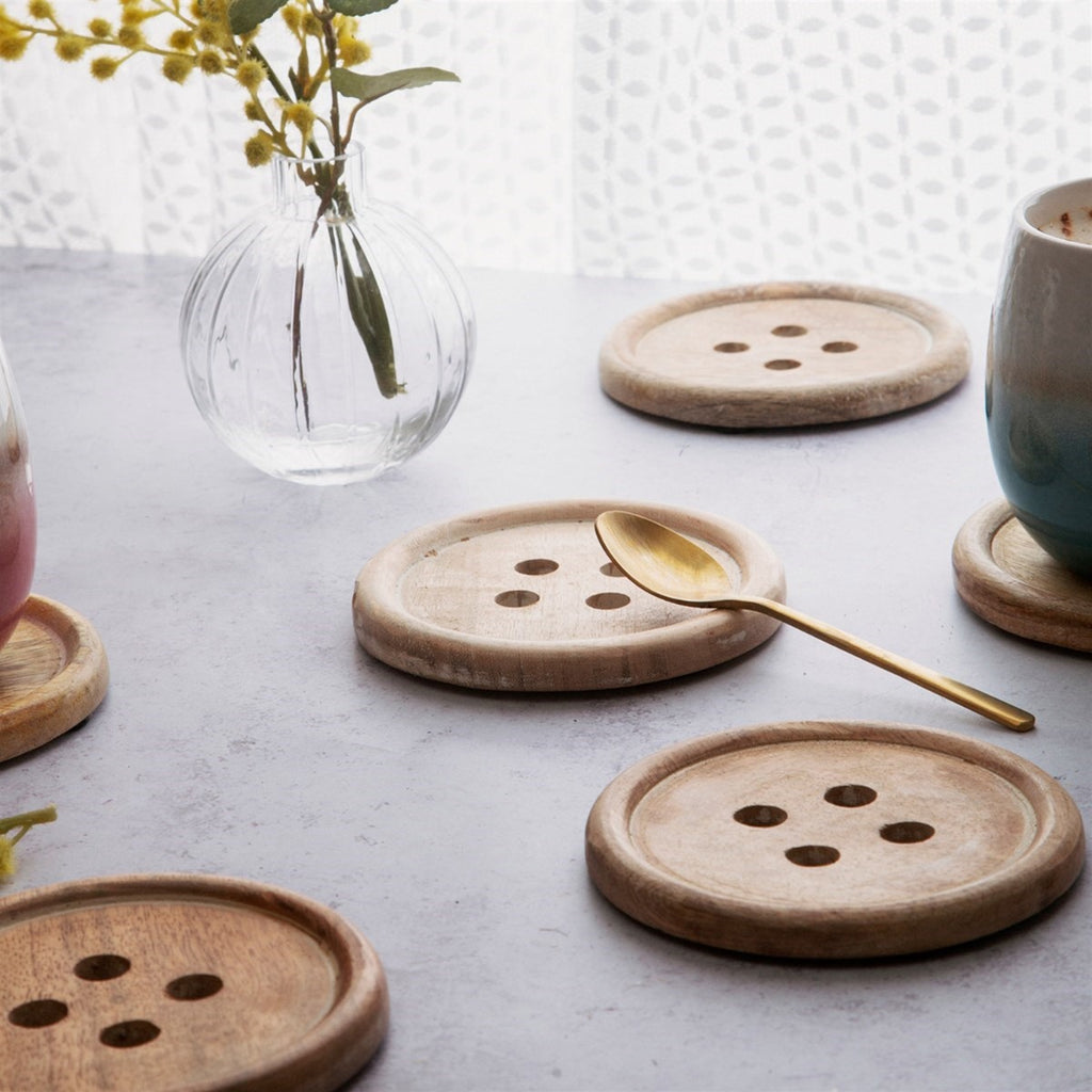 Wooden coasters holding metal spoon
