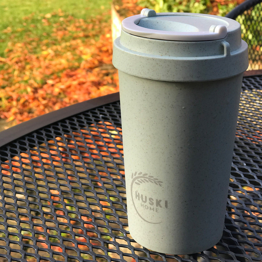 Duck egg coloured travel mug on park table