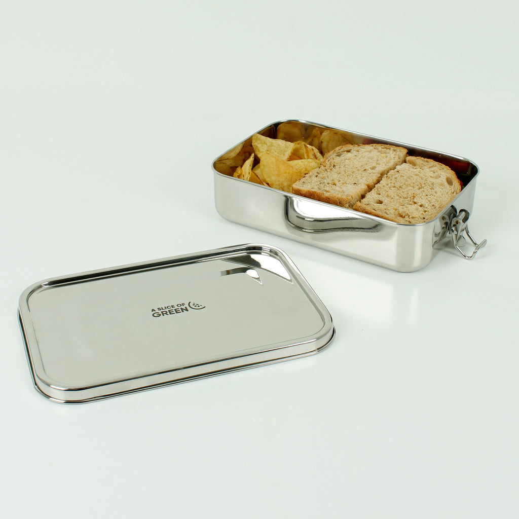 Stainless steel lunch box with sandwich and crisps inside, open lid beside with A Slice of Green branding