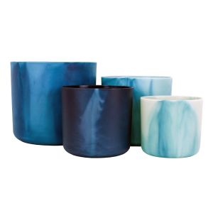 a set of four blue plastic indoor plant pots, made from recycled ocean waste